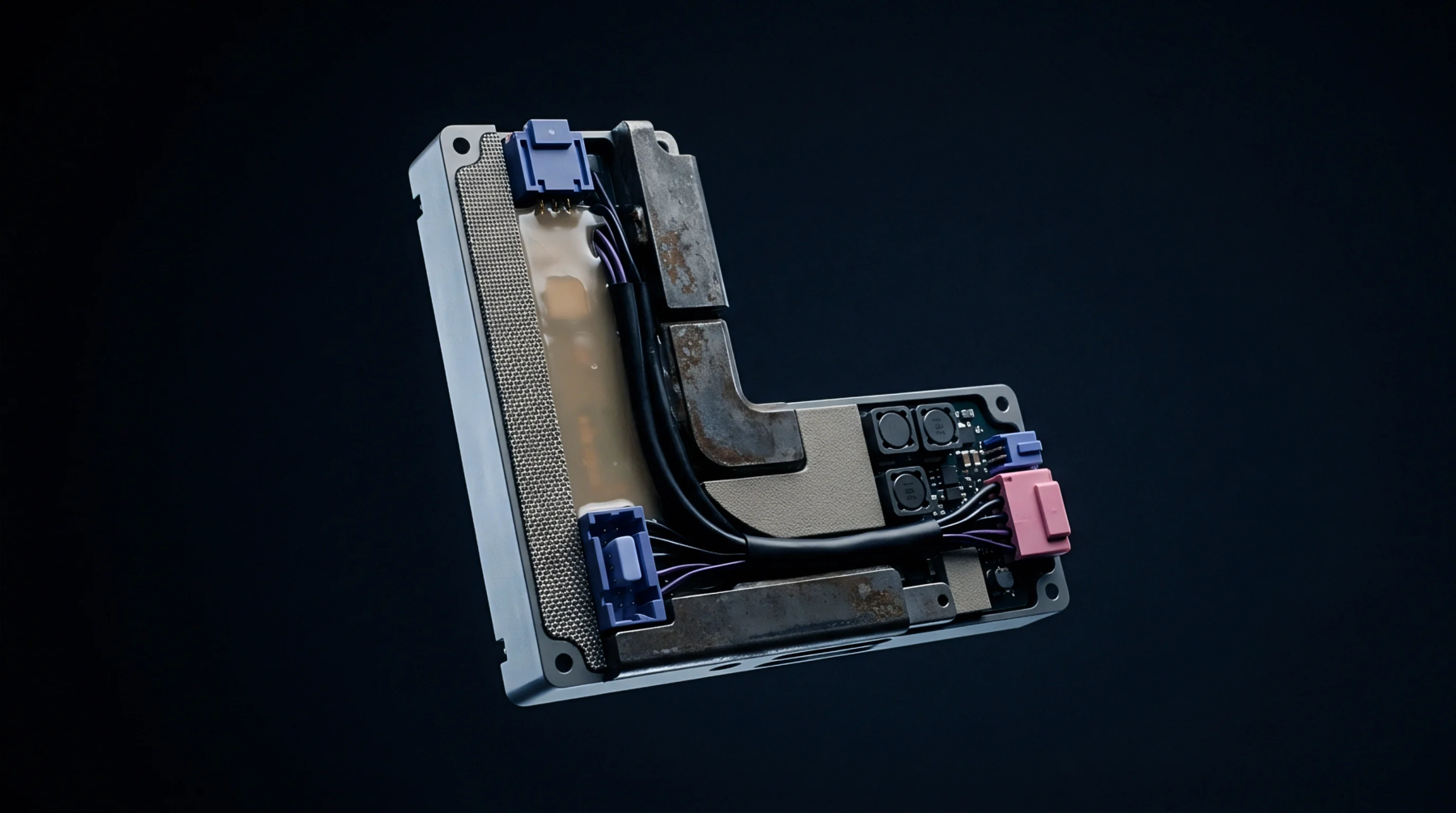 An L shaped metallic connectivity module houses internal wiring with blue and pink connectors inside a digital rendering space for hardware design.