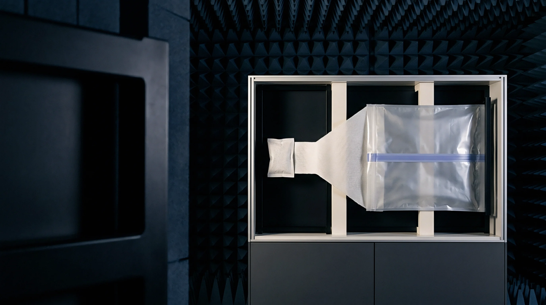 An enclosed smart device or connectivity module undergoes radio frequency characterization within an anechoic chamber environment.